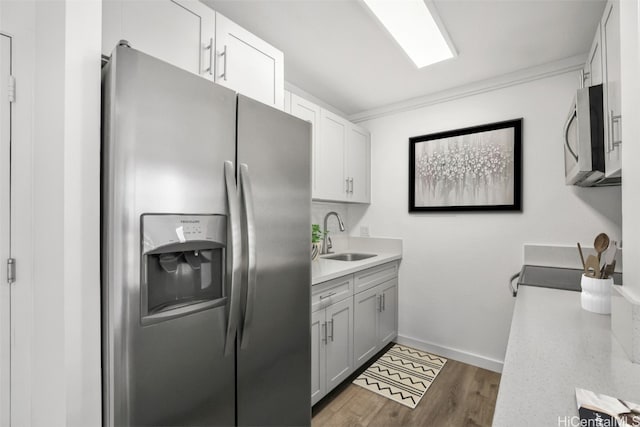 kitchen featuring white cabinets, sink, dark hardwood / wood-style floors, gray cabinets, and appliances with stainless steel finishes