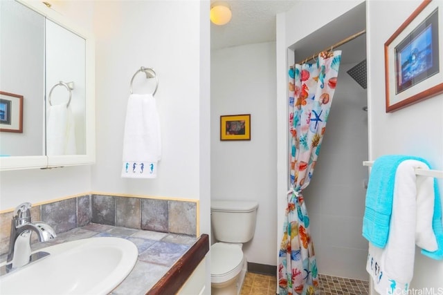 bathroom featuring a shower with shower curtain, a textured ceiling, vanity, and toilet