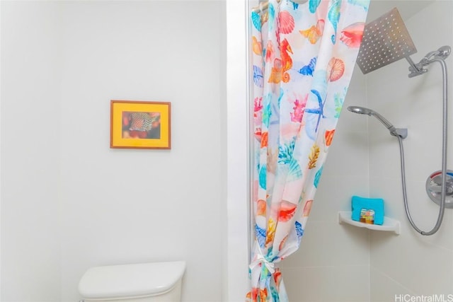 bathroom with curtained shower and toilet