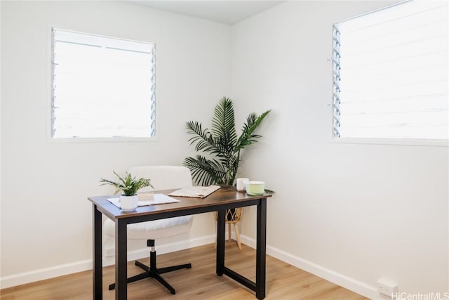 home office with light hardwood / wood-style floors