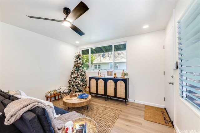 living area featuring ceiling fan and light hardwood / wood-style floors