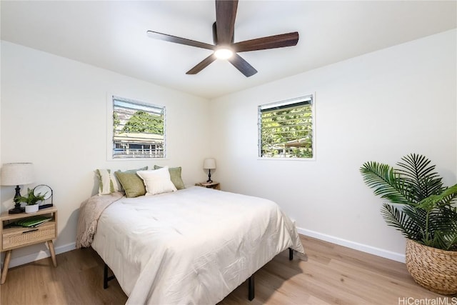 bedroom with light wood-type flooring and ceiling fan