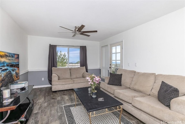 living room with dark hardwood / wood-style floors and ceiling fan