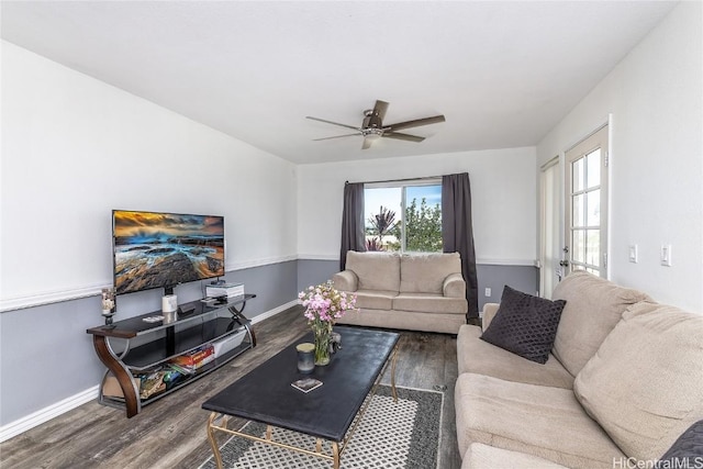 living room featuring dark hardwood / wood-style floors and ceiling fan