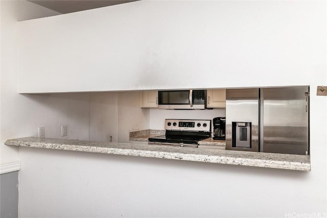 kitchen with light stone counters and stainless steel appliances