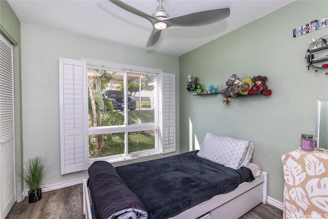 bedroom featuring ceiling fan, a closet, and dark wood-type flooring