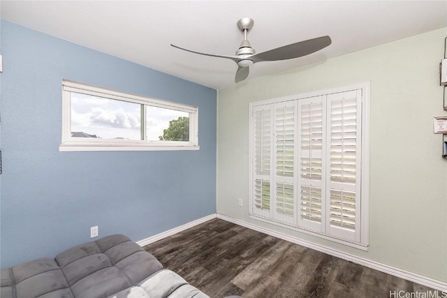 unfurnished room with dark hardwood / wood-style flooring and ceiling fan