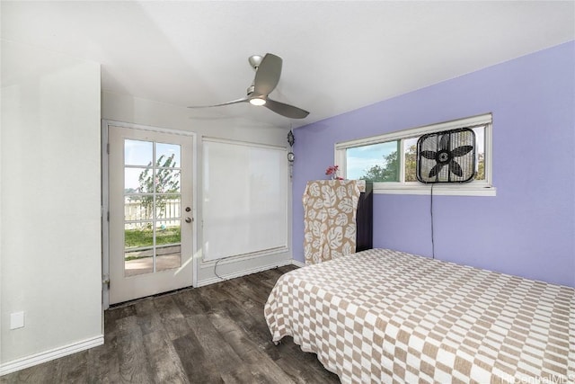 unfurnished bedroom featuring ceiling fan, dark wood-type flooring, access to outside, and multiple windows