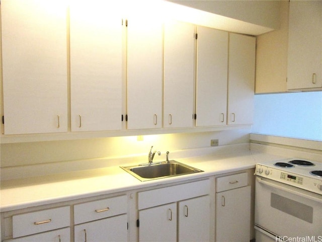 kitchen with sink, white cabinets, and white electric stove