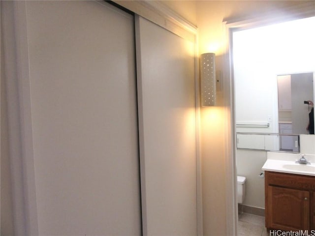 bathroom with tile patterned floors, vanity, and toilet