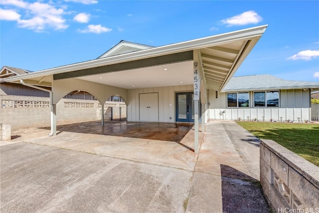 view of front facade with a carport and a front lawn