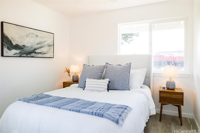 bedroom featuring wood-type flooring and multiple windows