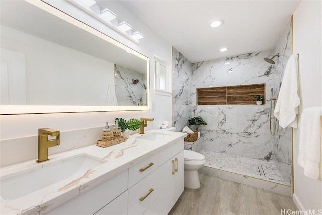 bathroom featuring toilet, hardwood / wood-style floors, vanity, and walk in shower