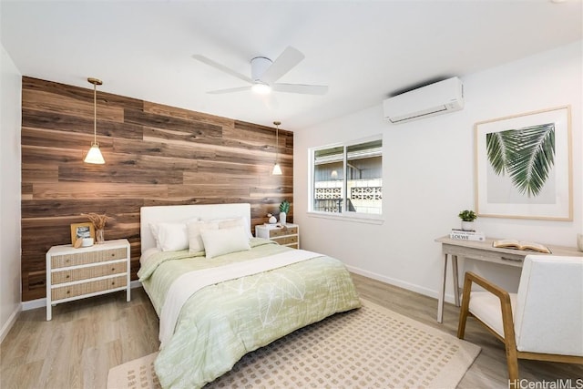 bedroom featuring a wall unit AC, wooden walls, ceiling fan, and wood-type flooring