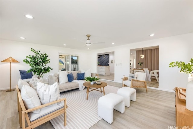 living room with ceiling fan and light hardwood / wood-style floors