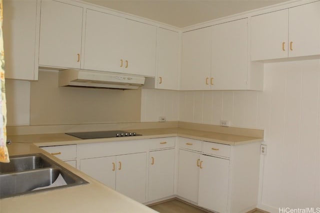 kitchen featuring white cabinetry, black electric stovetop, and sink