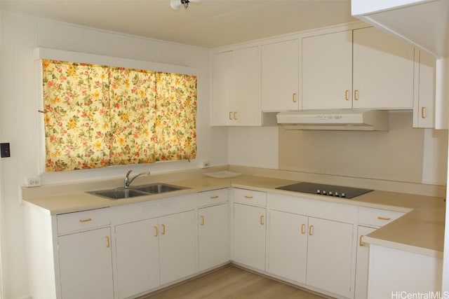 kitchen with white cabinetry, sink, and black electric cooktop