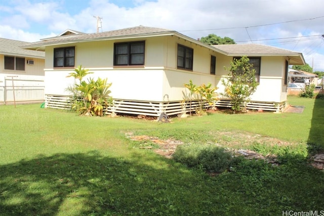 rear view of house with a yard