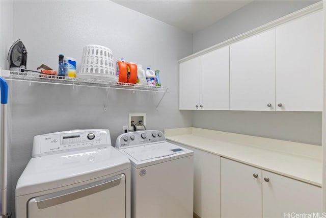 laundry room featuring cabinets and washing machine and clothes dryer