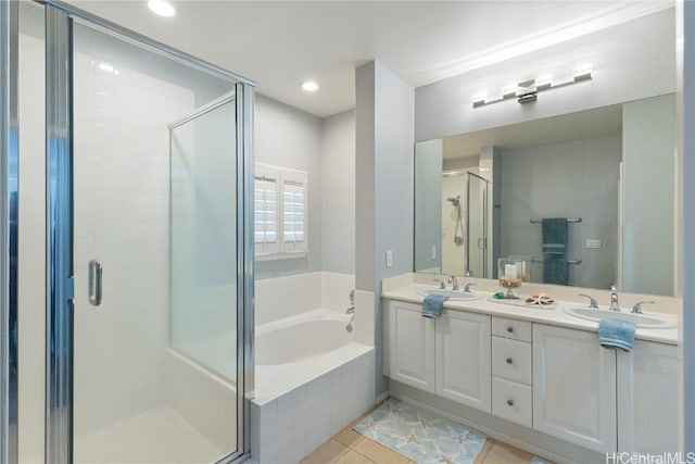 bathroom with tile patterned floors, vanity, and separate shower and tub