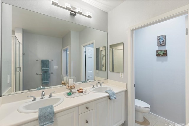 bathroom featuring tile patterned flooring, vanity, toilet, and walk in shower