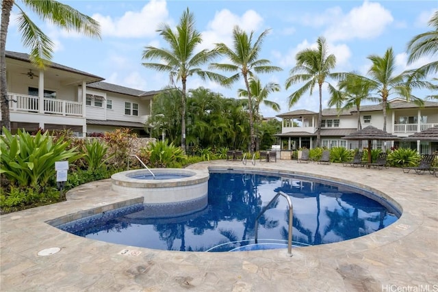 view of pool featuring a hot tub and a patio area