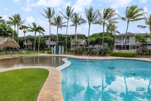 view of pool with a yard