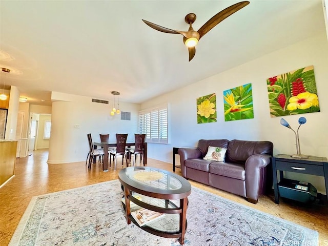 living room featuring light wood-type flooring and ceiling fan