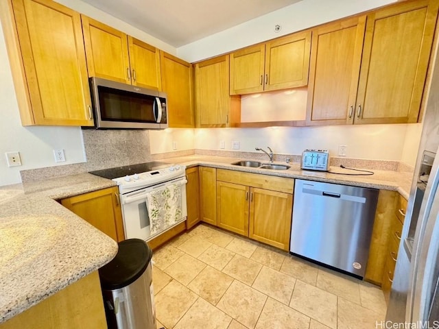 kitchen with decorative backsplash, light stone countertops, sink, and stainless steel appliances