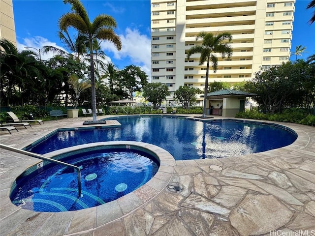 view of pool with a patio and a hot tub