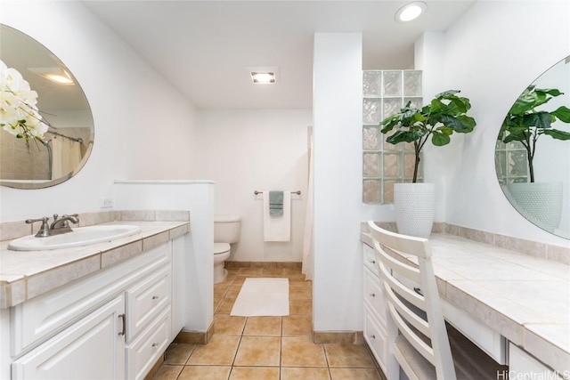 bathroom featuring tile patterned flooring, vanity, and toilet