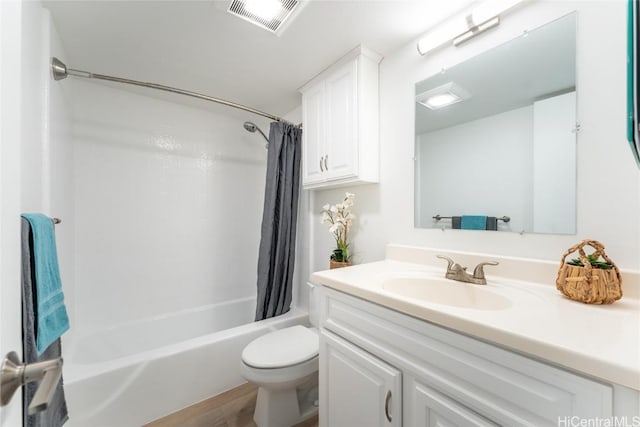 full bathroom featuring vanity, shower / bath combination with curtain, and toilet