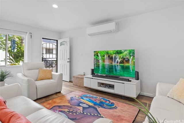 living room featuring wood-type flooring and a wall mounted air conditioner