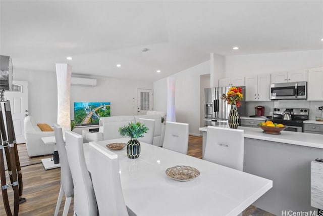 dining space featuring dark hardwood / wood-style flooring, a wall mounted air conditioner, and lofted ceiling