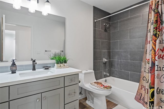 full bathroom featuring hardwood / wood-style floors, vanity, toilet, and shower / bath combo with shower curtain