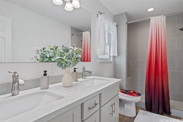 bathroom featuring hardwood / wood-style flooring, vanity, toilet, and walk in shower