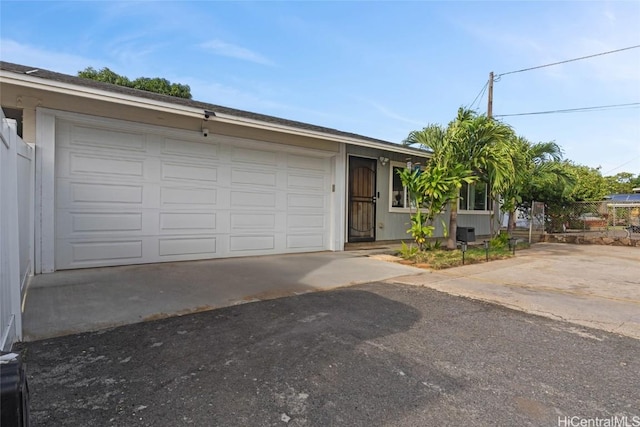 ranch-style home featuring a garage