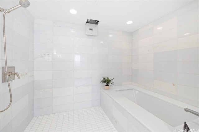 bathroom with tile patterned floors, tile walls, and independent shower and bath