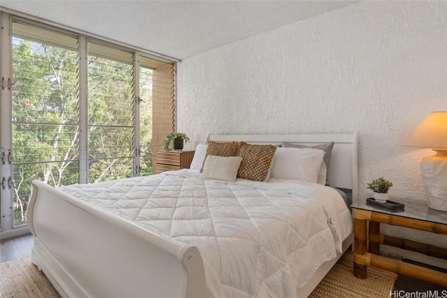 bedroom featuring a textured ceiling and multiple windows