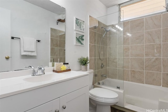 full bathroom with vanity, toilet, and tiled shower / bath