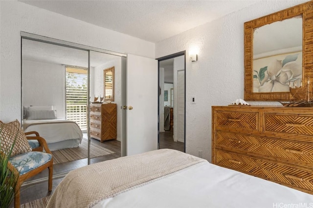 bedroom with hardwood / wood-style floors, a textured ceiling, and a closet