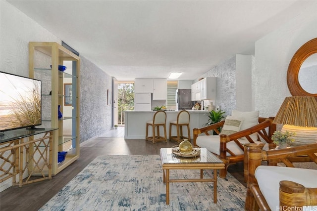 sitting room featuring dark wood-type flooring