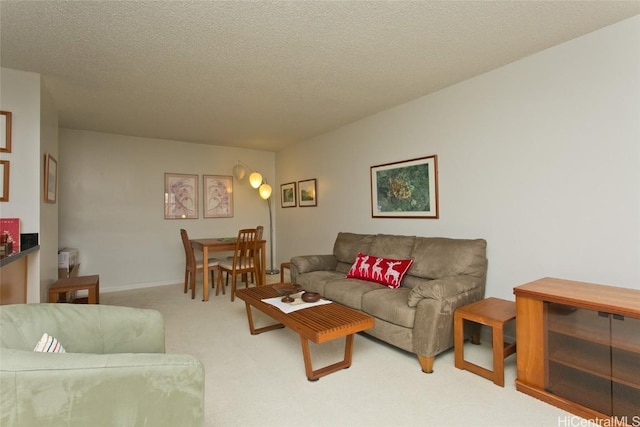 living room with light carpet and a textured ceiling