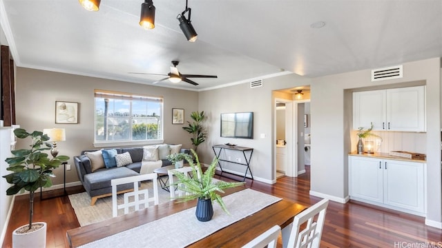 living room featuring crown molding, ceiling fan, and dark hardwood / wood-style floors