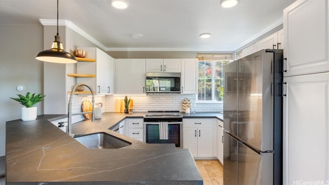 kitchen featuring kitchen peninsula, stainless steel appliances, and white cabinets