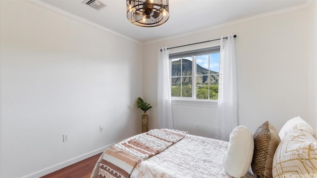 bedroom featuring dark hardwood / wood-style flooring and ornamental molding