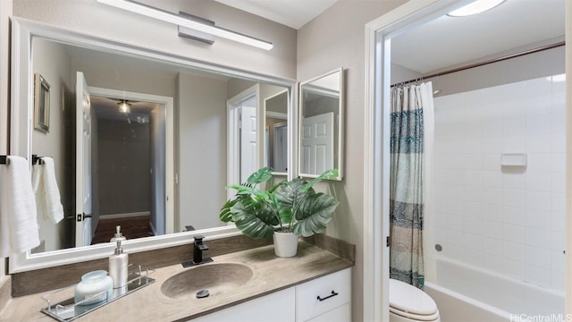 full bathroom with toilet, vanity, and shower / tub combo with curtain