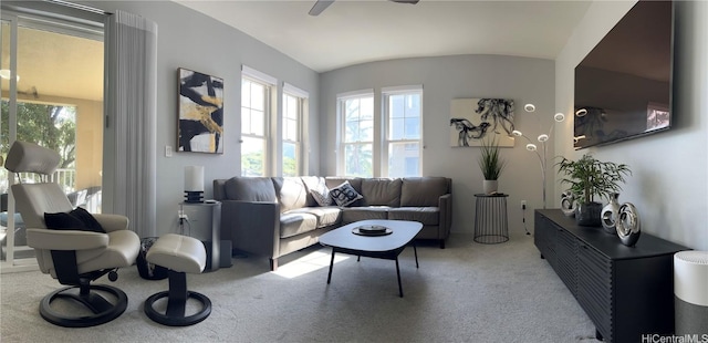 living room featuring plenty of natural light, light colored carpet, and vaulted ceiling