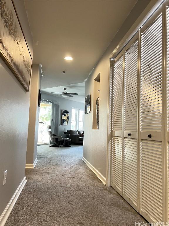 hallway with carpet floors