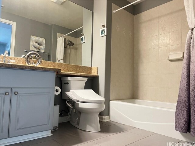 full bathroom featuring shower / bath combo with shower curtain, tile patterned flooring, vanity, and toilet